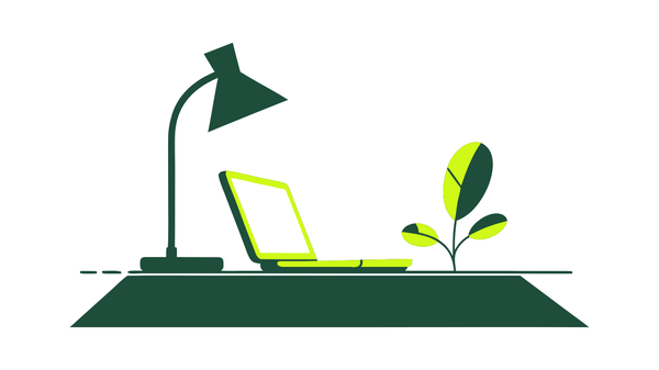 A desk lamp spotlighting a small laptop