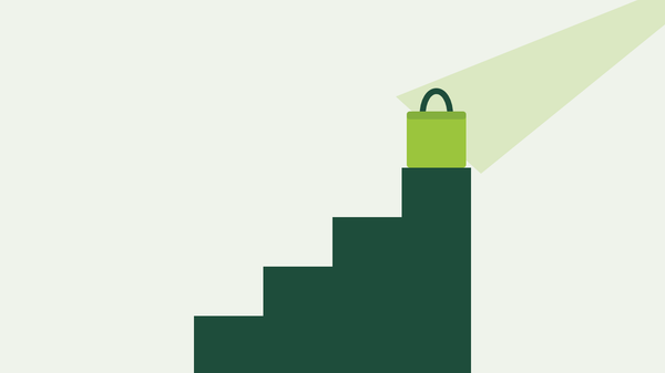 A lime tote bag on the top step of a dark green staircase, lit by a spotlight beam